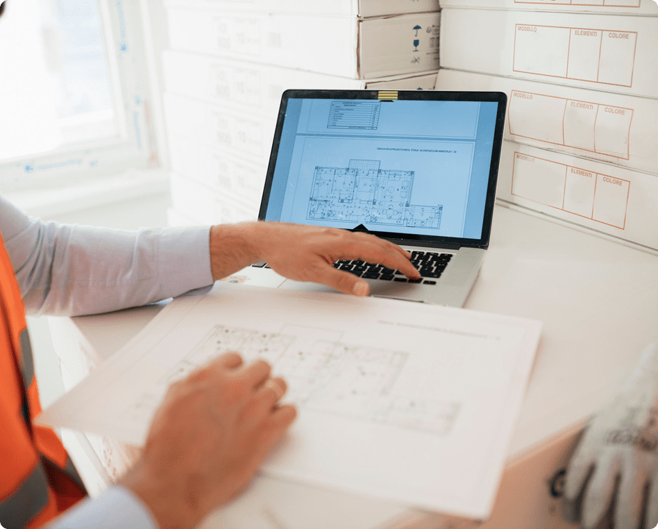 Person examining architectural designs on computer.