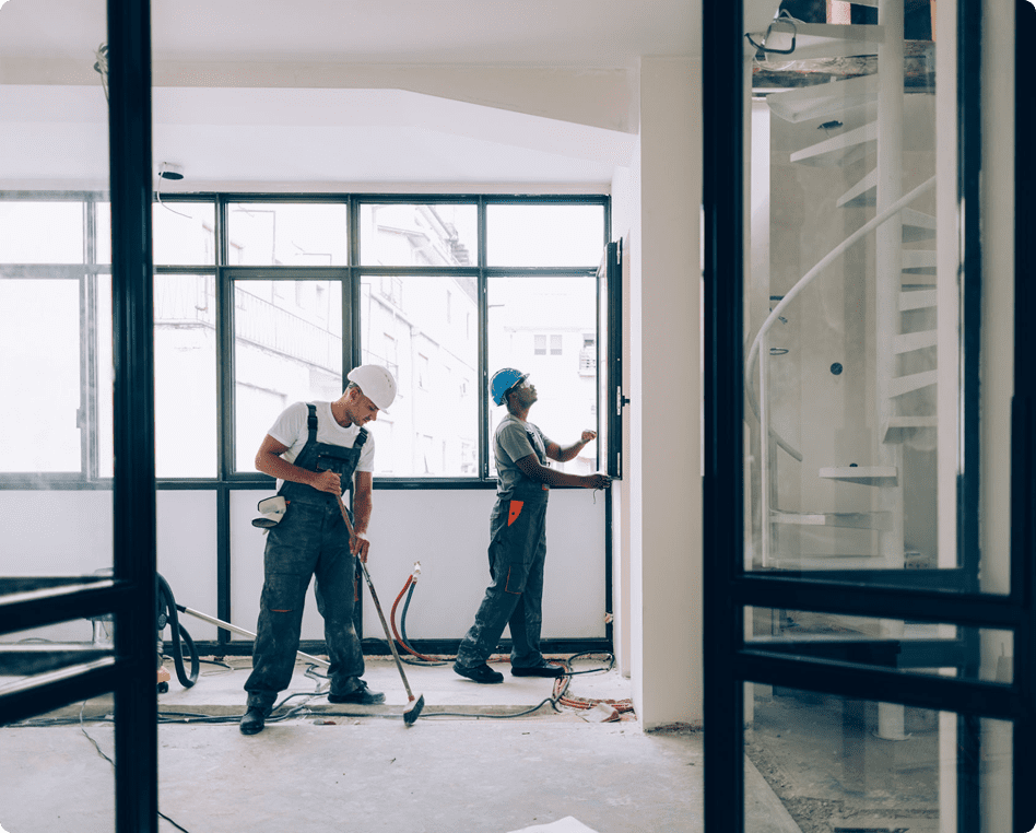 Workers installing windows in a building