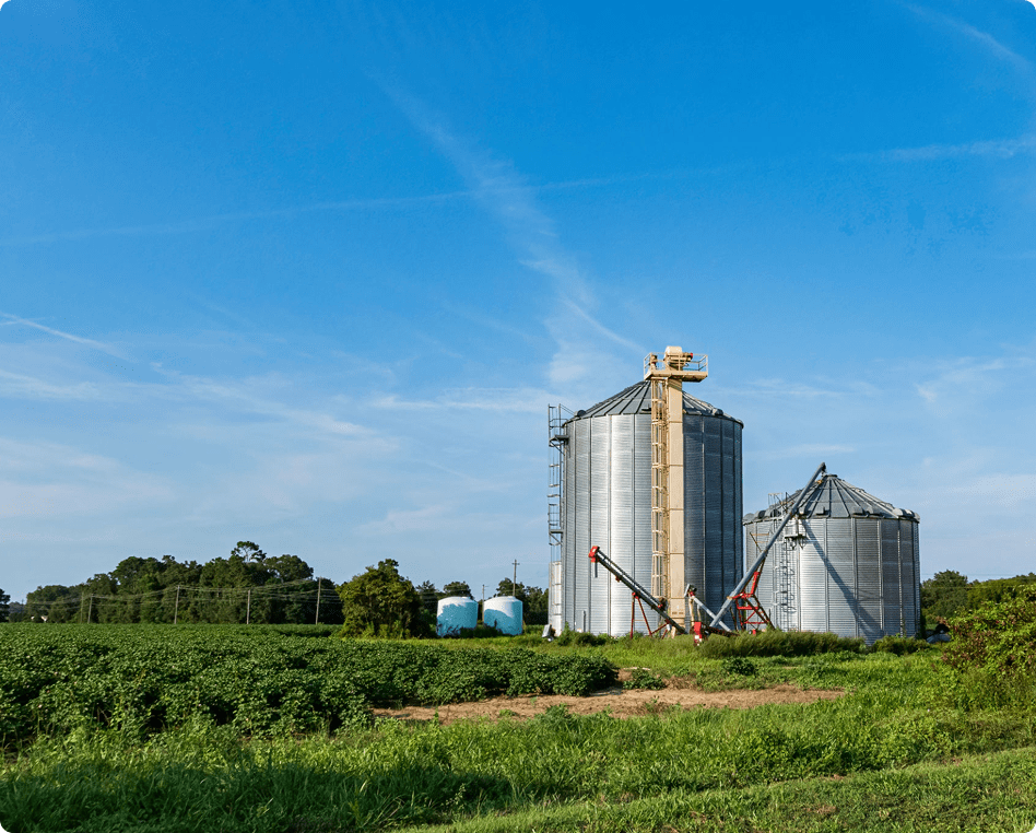 Grain silos beside green field