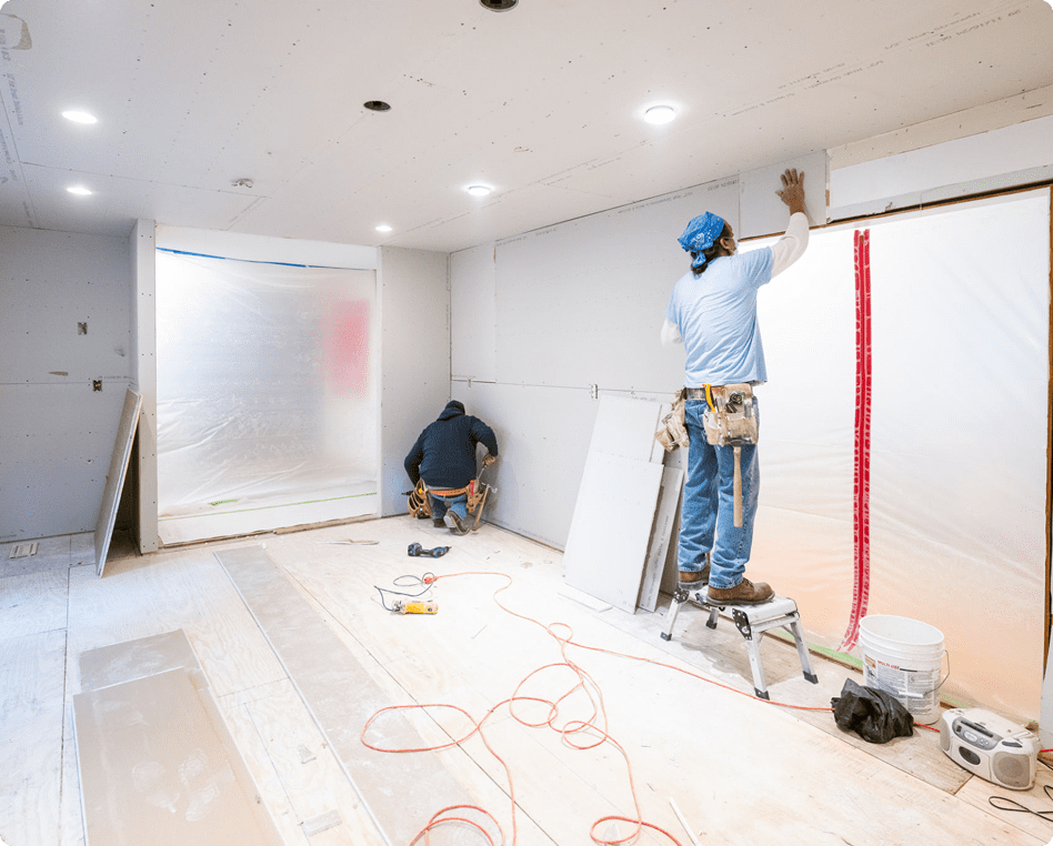 Construction workers fixing walls