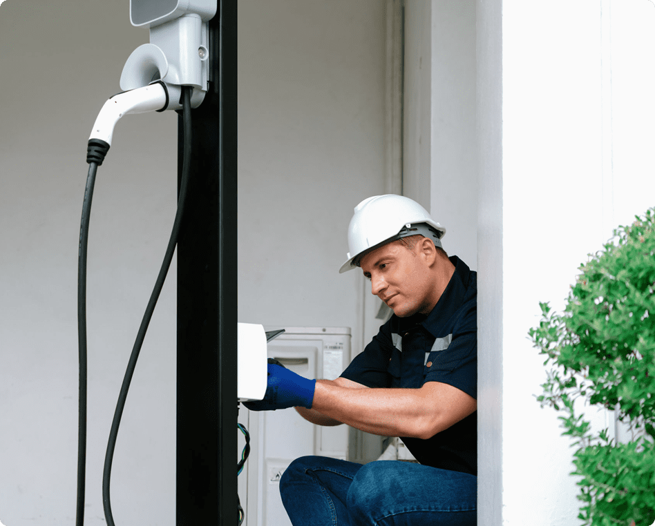 Worker setting up EV charging station