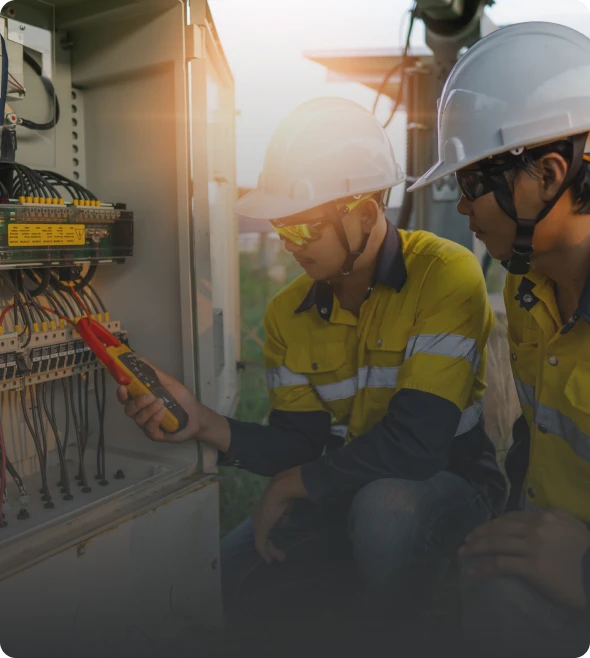 Two workers checking electrical wiring.